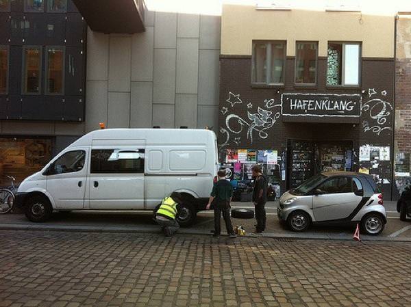 Biff (in hi-vis jacket) repairs the Bedlam Six van